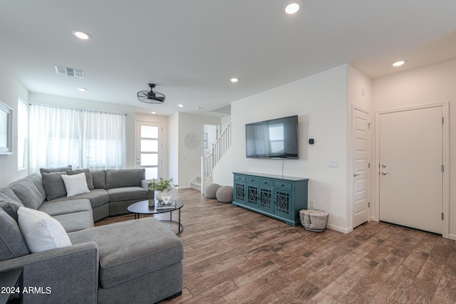 living area featuring stairway, wood finished floors, visible vents, baseboards, and recessed lighting