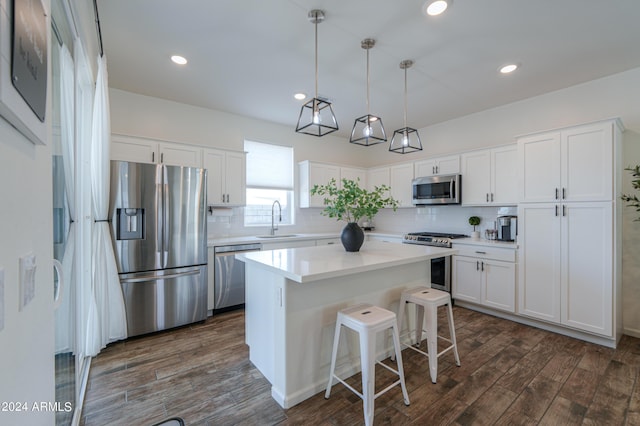 kitchen with white cabinetry, dark wood-style floors, appliances with stainless steel finishes, and a sink