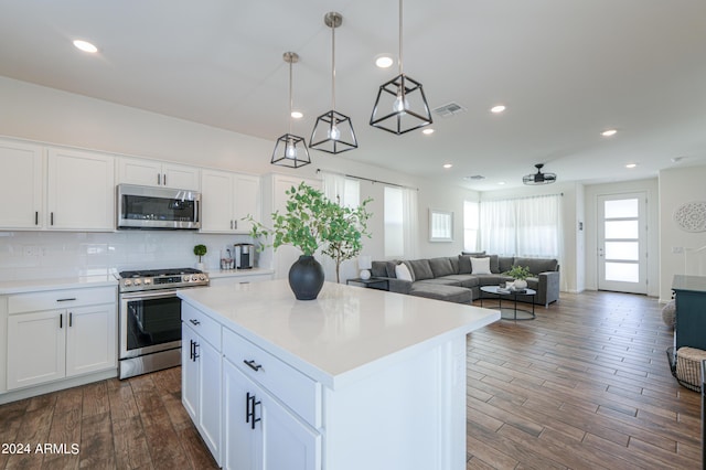 kitchen featuring visible vents, stainless steel appliances, light countertops, white cabinets, and tasteful backsplash