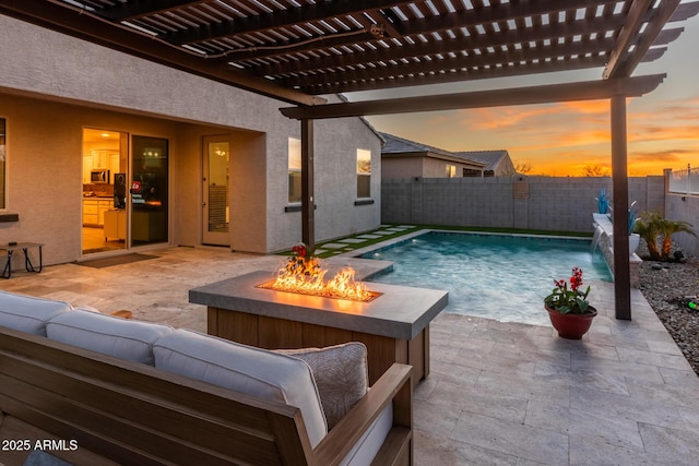 pool at dusk featuring an outdoor living space with a fire pit, a patio area, a fenced backyard, and a pergola