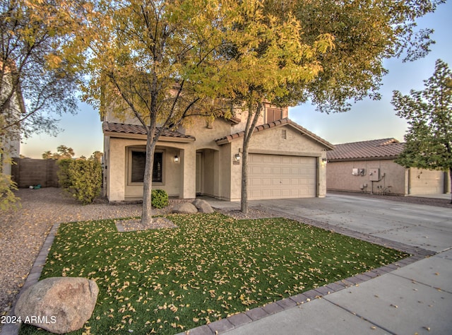 mediterranean / spanish home featuring a garage