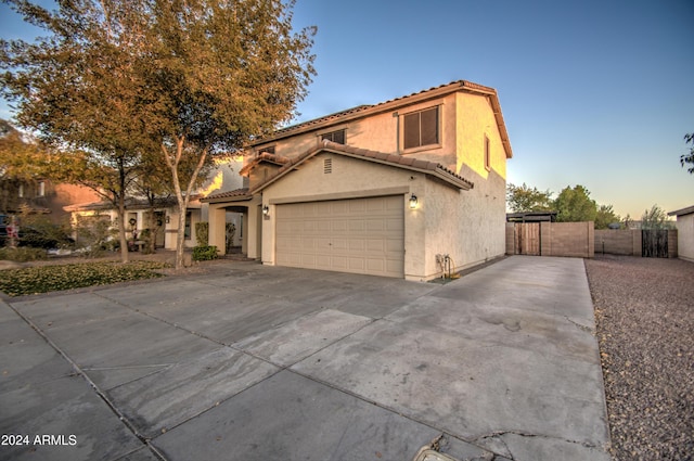 mediterranean / spanish house with a garage