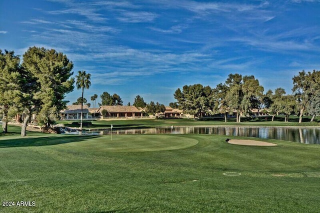 view of property's community with a yard and a water view