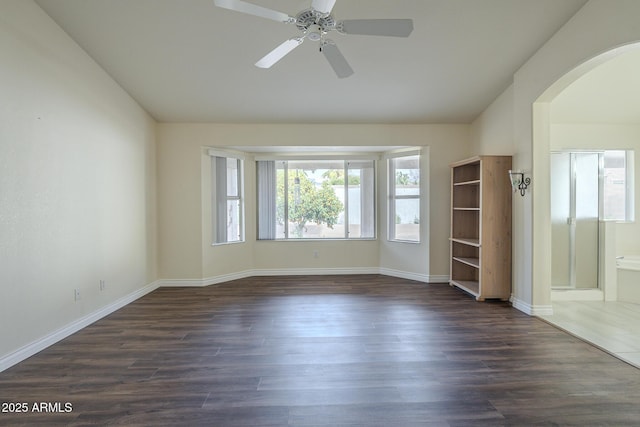 unfurnished room featuring ceiling fan and dark wood-type flooring