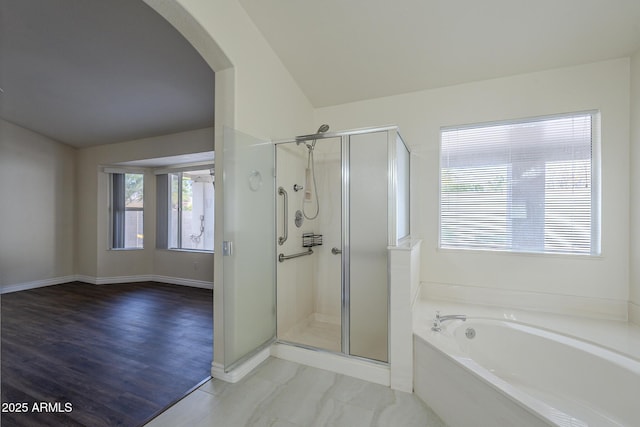 bathroom featuring separate shower and tub and lofted ceiling