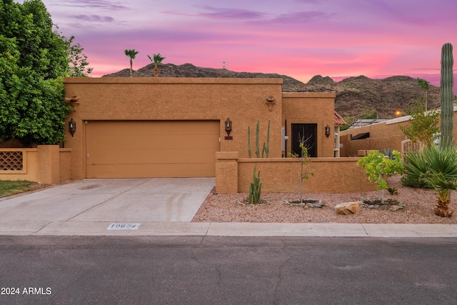 southwest-style home featuring a mountain view and a garage