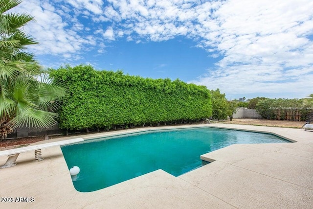 3102 W Betty Elyse Ln, Phoenix, AZ 85053 - view of swimming pool with a diving board, a fenced backyard, and a patio