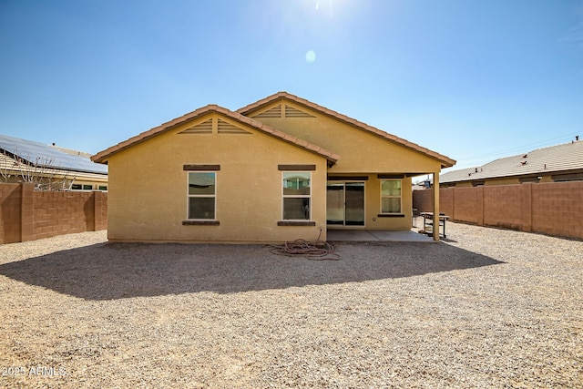 back of house with a patio area, a fenced backyard, and stucco siding