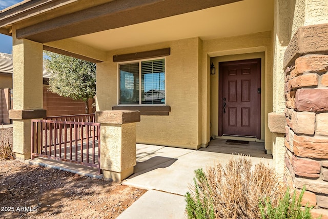 view of exterior entry with stucco siding