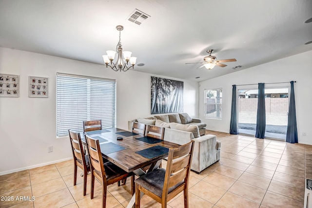 dining room featuring light tile patterned floors, visible vents, vaulted ceiling, and ceiling fan with notable chandelier