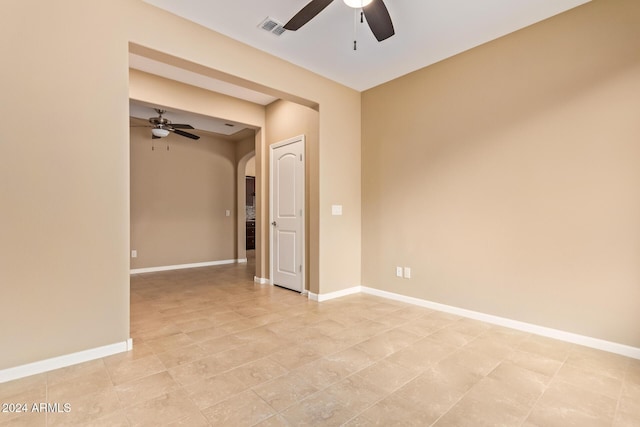 spare room featuring ceiling fan and light tile patterned floors