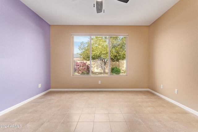 empty room featuring ceiling fan and light tile patterned floors