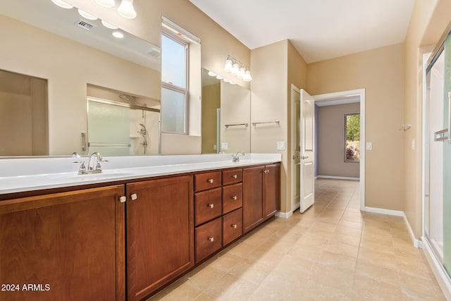 bathroom with tile patterned flooring, vanity, and walk in shower