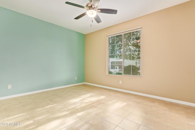 spare room featuring ceiling fan and light tile patterned flooring