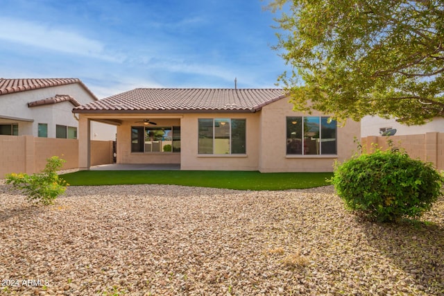 rear view of house with ceiling fan and a patio area