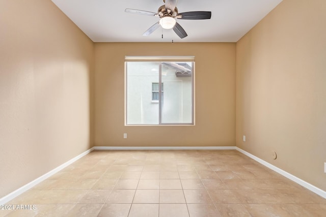 spare room with light tile patterned floors and ceiling fan