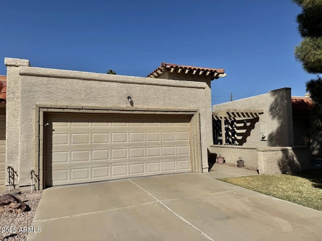 garage featuring concrete driveway