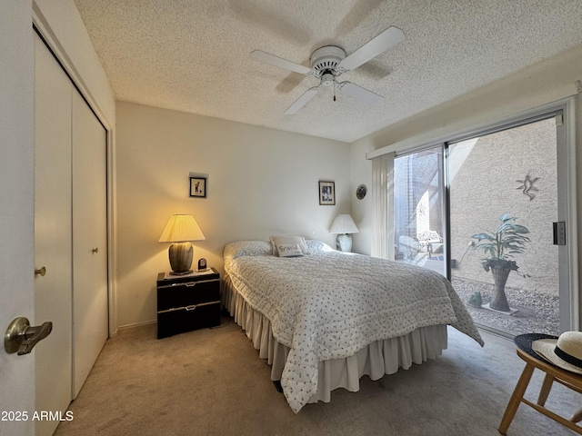 bedroom featuring light carpet, a ceiling fan, access to outside, a textured ceiling, and a closet