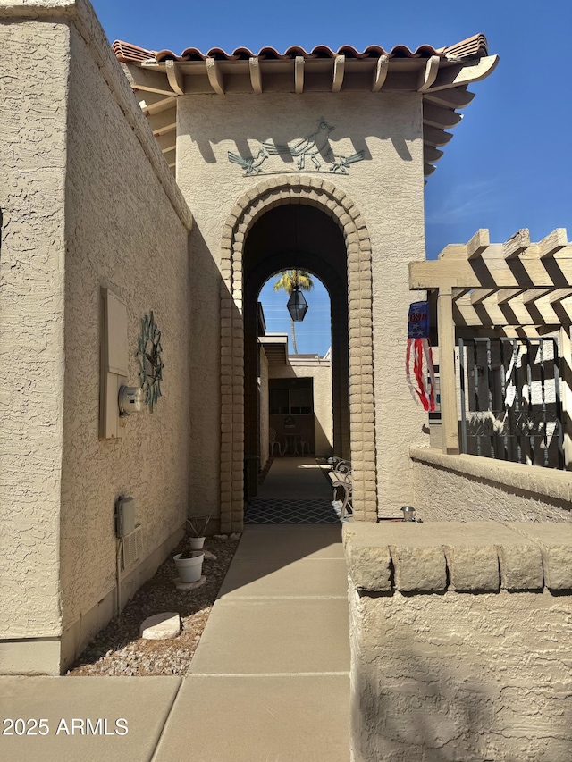 entrance to property featuring stucco siding