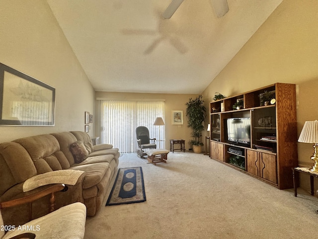 living room with vaulted ceiling, a ceiling fan, and light colored carpet