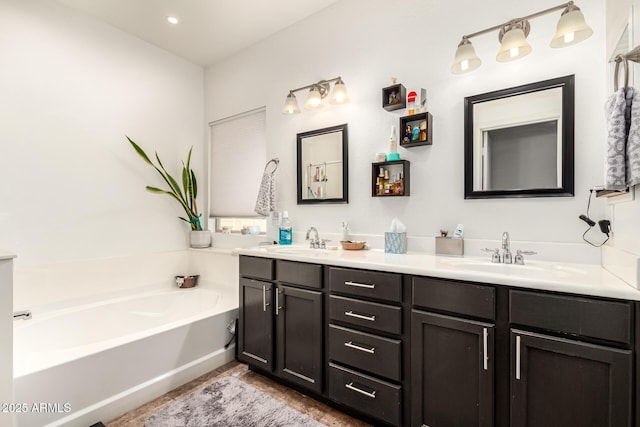 bathroom featuring vanity and a bath