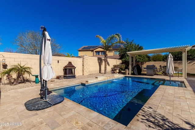 view of pool with a patio area, a pergola, and pool water feature