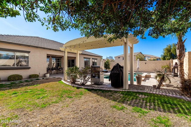 rear view of property with a yard, a pergola, a fenced in pool, and a patio area