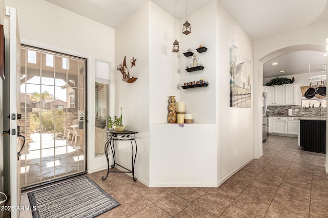 tiled foyer entrance featuring sink