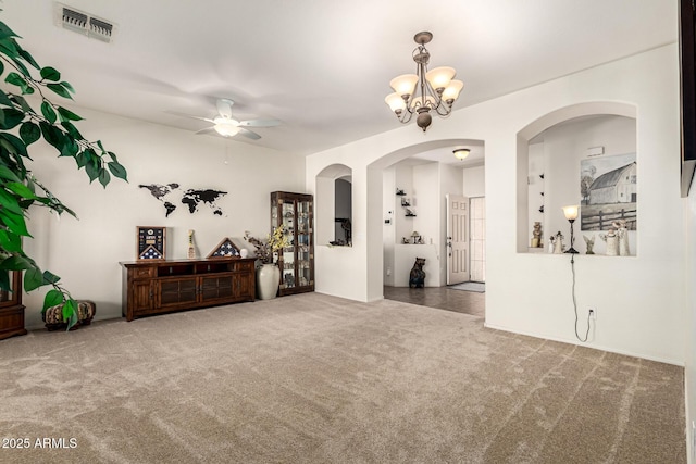 spare room with carpet floors and ceiling fan with notable chandelier