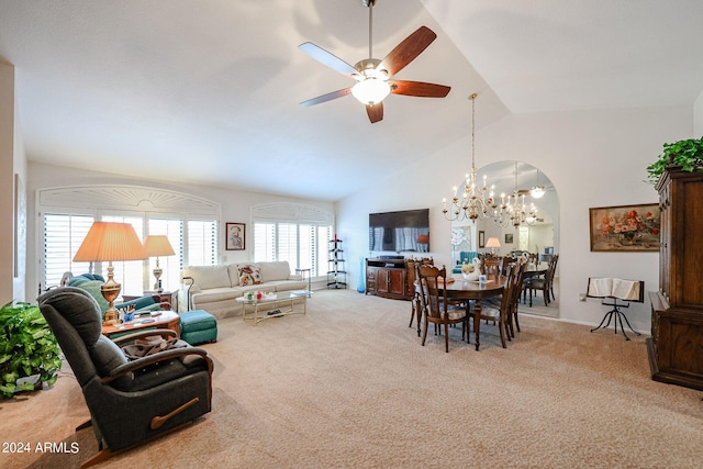 carpeted living room featuring ceiling fan with notable chandelier, plenty of natural light, and high vaulted ceiling