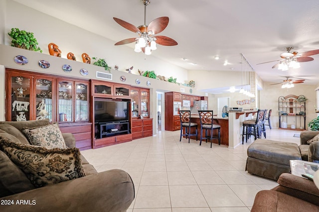 living room featuring ceiling fan, light tile patterned floors, and high vaulted ceiling