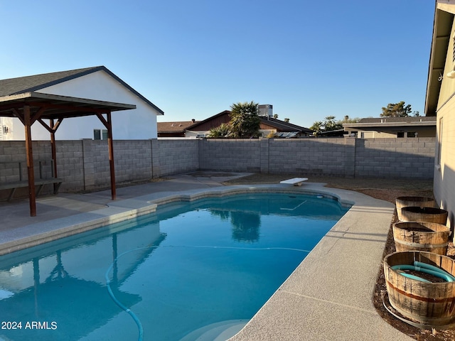 view of swimming pool featuring a diving board and a gazebo