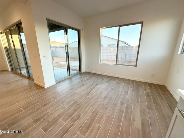 empty room with light hardwood / wood-style flooring