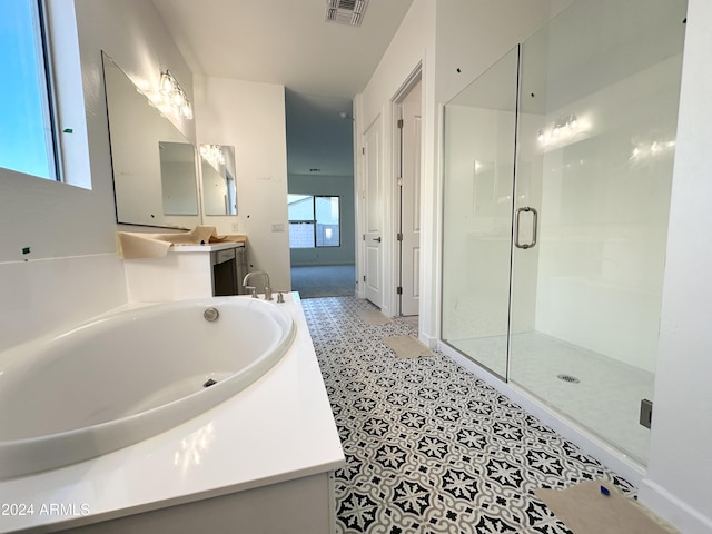 bathroom featuring plenty of natural light, vanity, and separate shower and tub