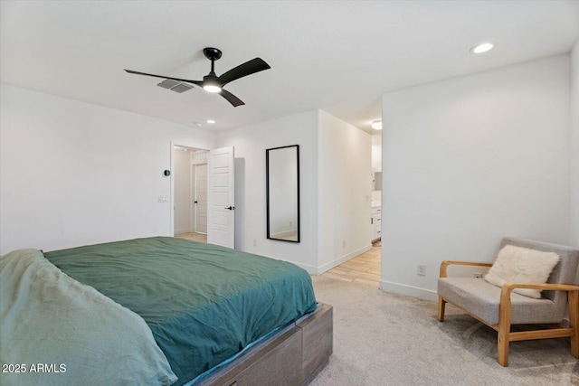 carpeted bedroom featuring connected bathroom and ceiling fan