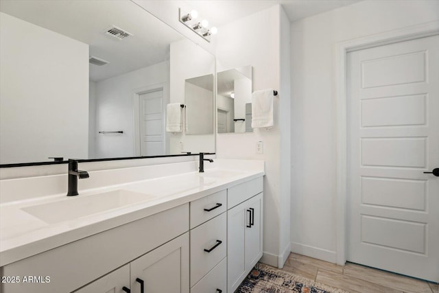 bathroom featuring vanity and hardwood / wood-style floors