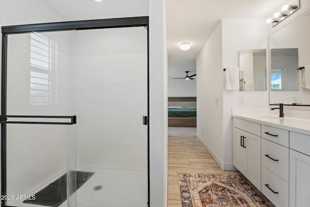 bathroom with vanity, an enclosed shower, and ceiling fan