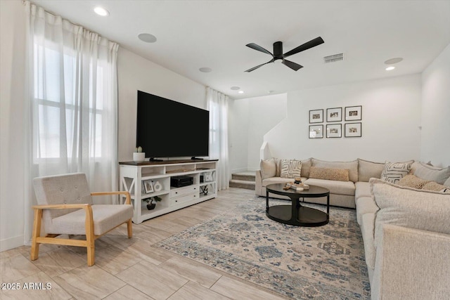 living room with plenty of natural light and ceiling fan