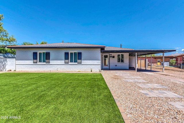 ranch-style house with a front yard and a carport