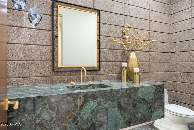 half bath featuring toilet, tile patterned floors, and vanity