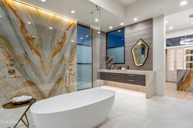 full bath with recessed lighting, tile walls, vanity, a soaking tub, and walk in shower