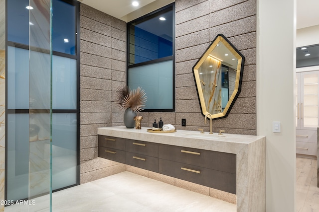 bathroom featuring double vanity and a sink