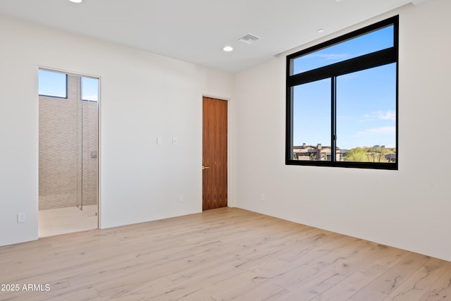 spare room with recessed lighting, visible vents, and wood finished floors