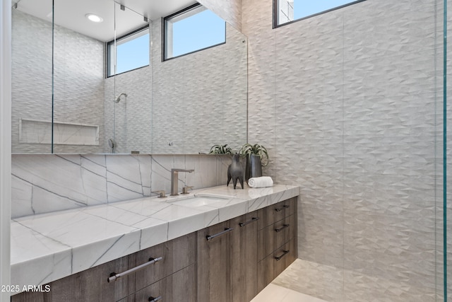 bathroom with a shower, backsplash, and vanity