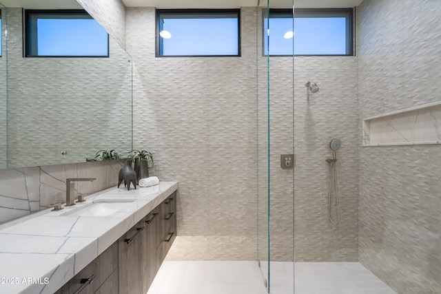 bathroom with a shower stall and vanity