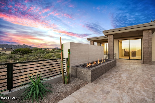 patio terrace at dusk with a fire pit