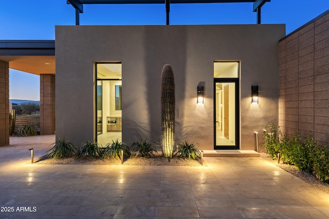 view of front of property featuring a patio and stucco siding