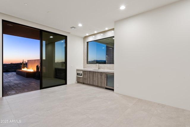 spare room featuring a sink, visible vents, and recessed lighting