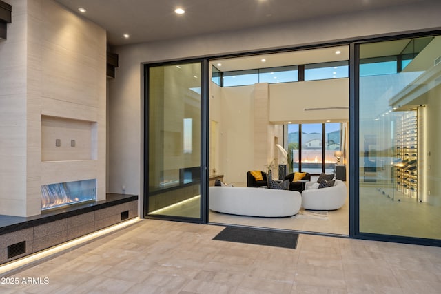 interior space with a tile fireplace and visible vents