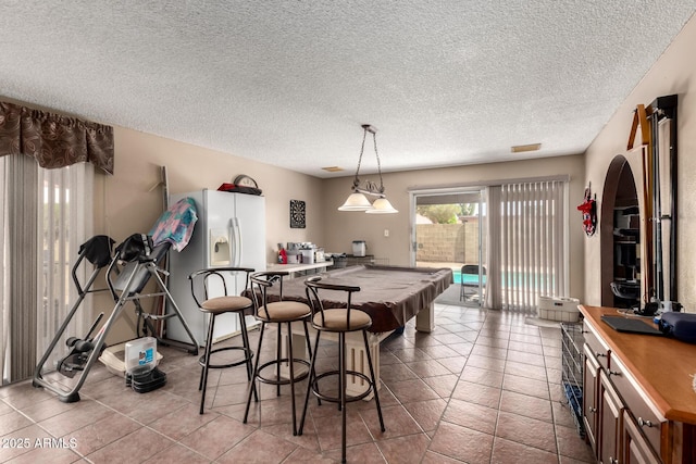 4957 W Onyx Ave, Glendale, AZ 85302 - tiled dining area featuring a textured ceiling, billiards, and arched walkways